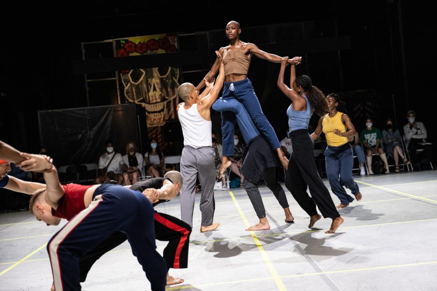 Group of dancers lifting person on the right