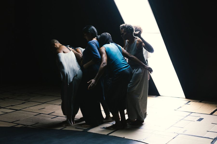 Group of Black performers standing closely to each other